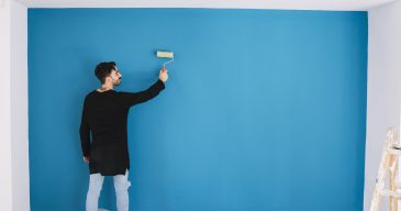 man-painting-blue-wall