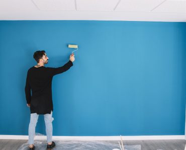 man-painting-blue-wall