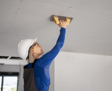 medium-shot-smiley-woman-fixing-roof