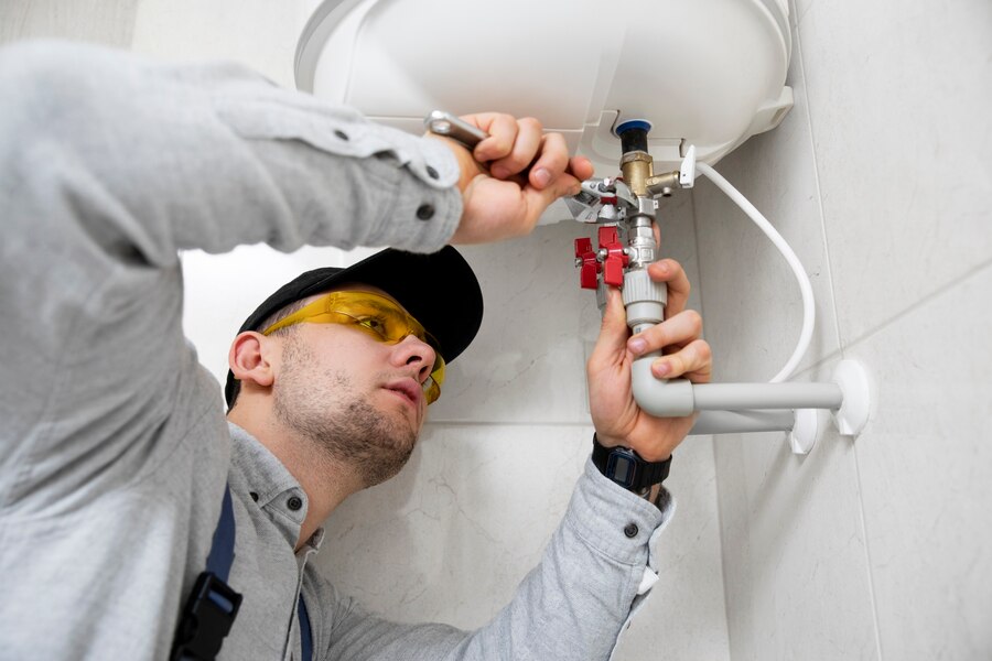 worker-repairing-water-heater_23-2149334230